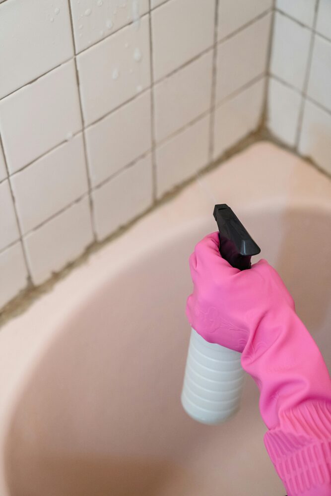 Mould remover spray being used in a bathroom area